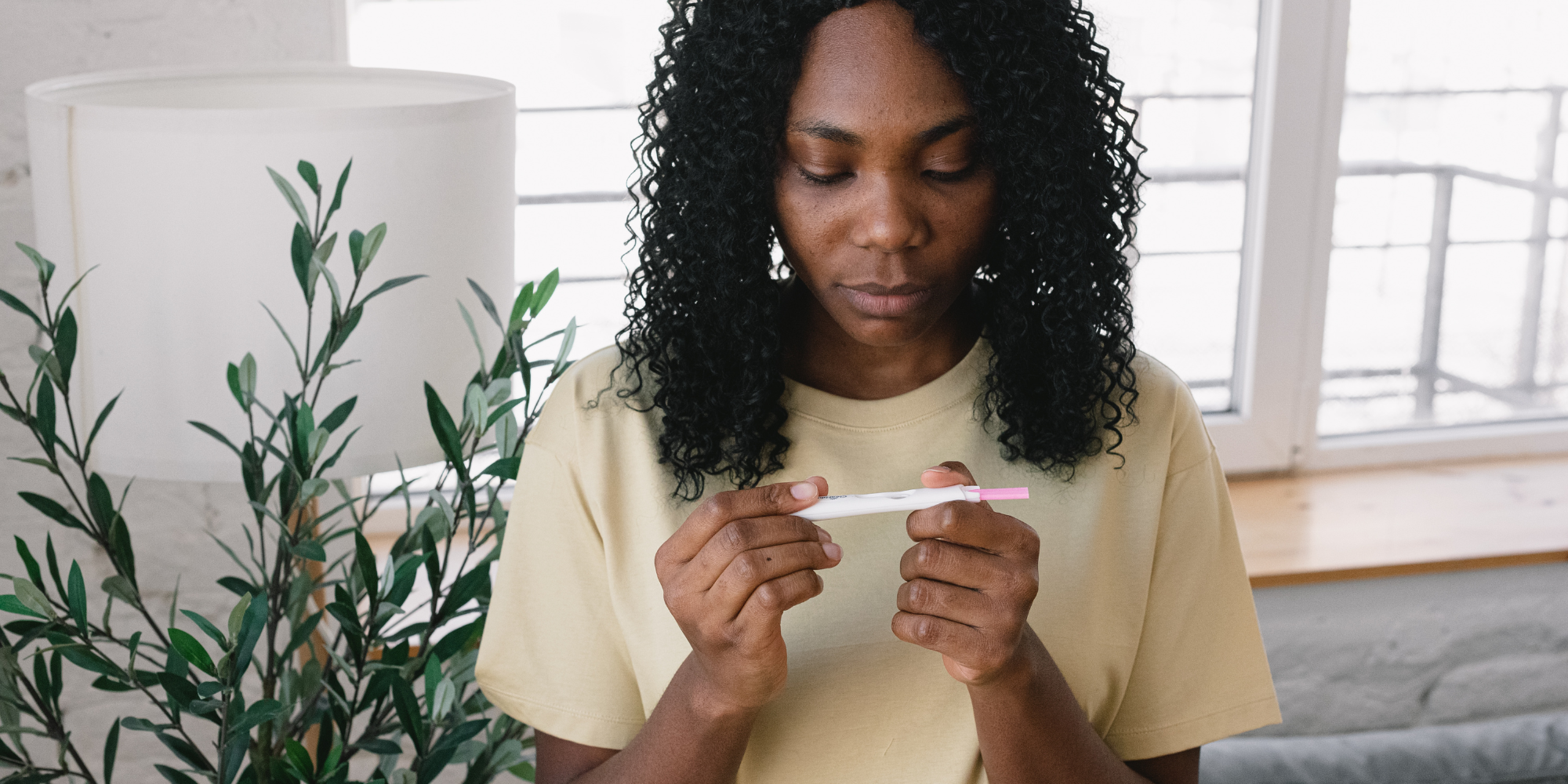 woman looking at pregnancy test