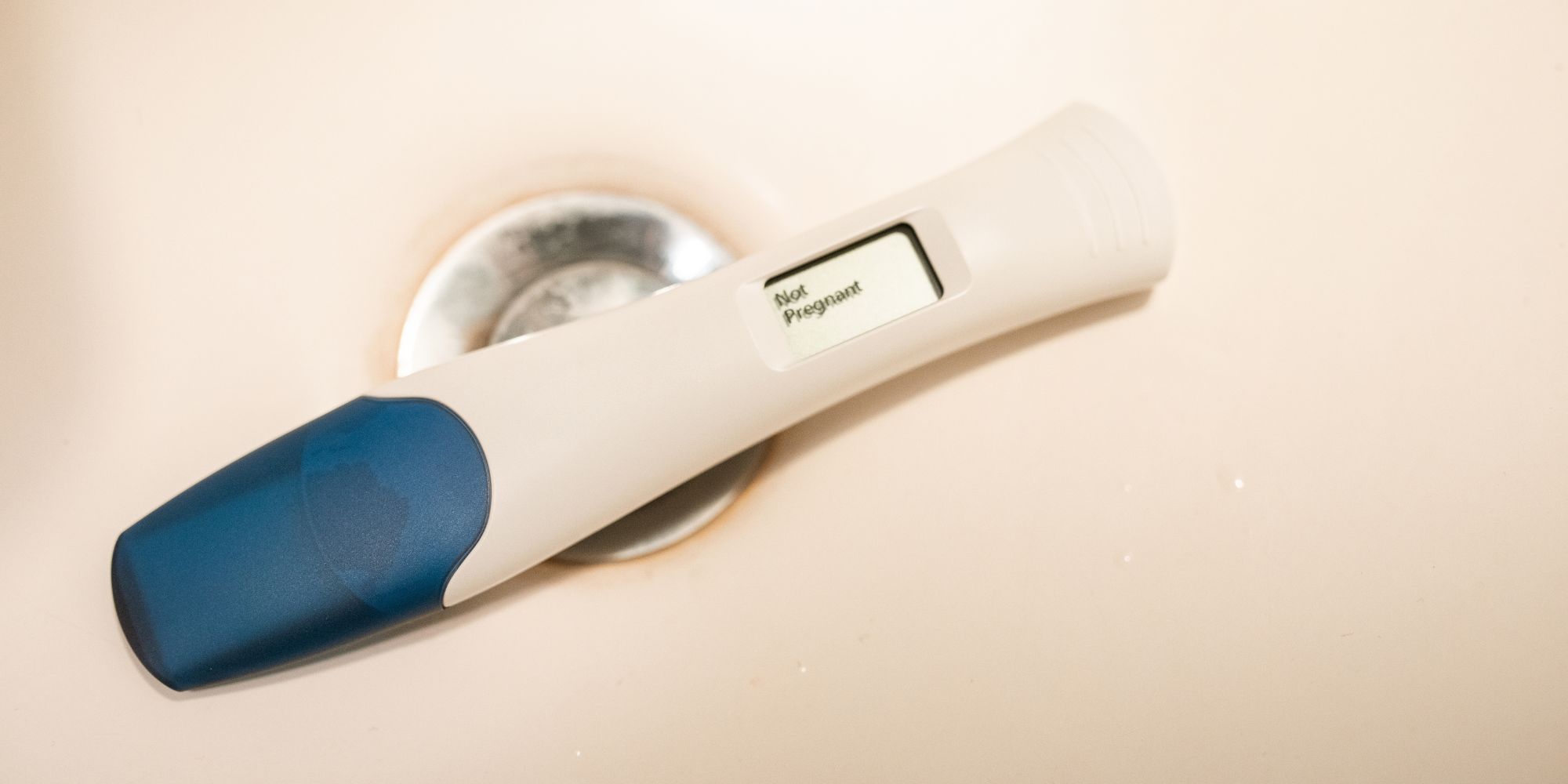 woman looking at pregnancy test