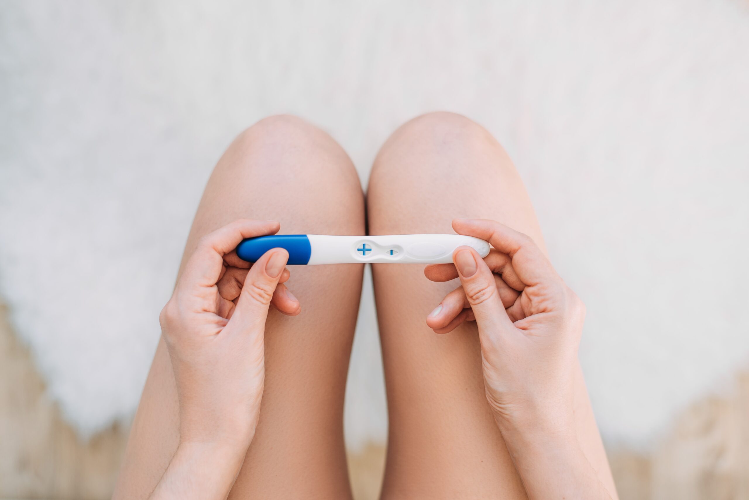 Woman Sit In The Toilet Hold Pregnancy Test. Woman Holding A Pre